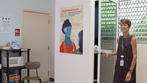  Deborah Mattheus displays a poster at Castle High School’s health clinic.