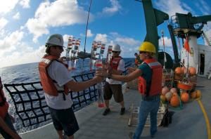 HOT scientists recovering sampling equipment on the deck of the UH Research Vessel Kilo Moana. 