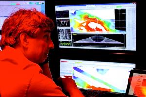 Christopher Kelley monitoring incoming data in the sonar control room. Credit: Dan Wagner/NOAA