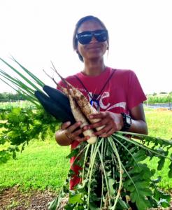 Agriculture student Chyane Kolish holds some of the vegetables grown by Hawai'i CC students.