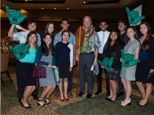 Shidler business students congratulate Shidler Dean Vance Roley at Salesperson of the Year luncheon.