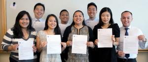 Having completed Imi, the students hold their acceptance letters into UH medical school.