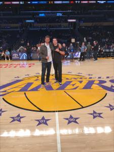 Jamie Newirth, at left, with friend Marlin Henton at halftime on the Staples Center court.