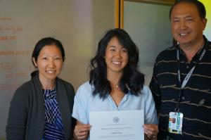 Elisabeth Young is presented the Public Health Service Award by Drs. Burgess and Teranishi of JABSOM.